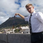 Bryant burning a tie to celebrate reaching the 6 month mark.